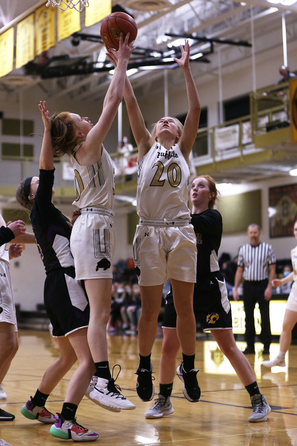 Grace Peterson, left, and sophomore Hannah Qualm stretch